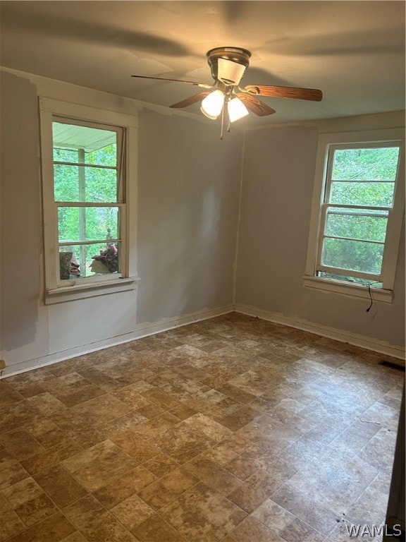 unfurnished room with ceiling fan