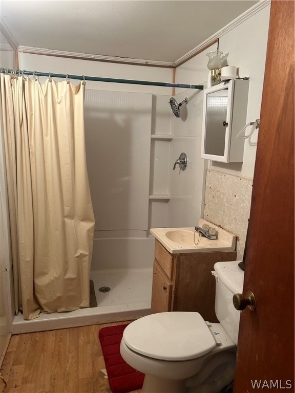 bathroom with walk in shower, vanity, crown molding, wood-type flooring, and toilet