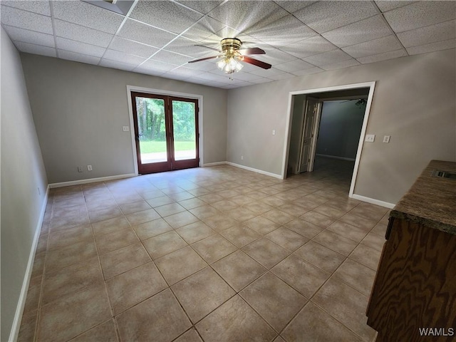 14541 Keenes Mill Rd, Coaling, AL 35453 - tiled empty room with a drop ceiling, ceiling fan, and baseboards