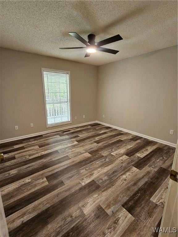 14541 Keenes Mill Rd, Coaling, AL 35453 - empty room with dark wood-style flooring, a textured ceiling, a ceiling fan, and baseboards