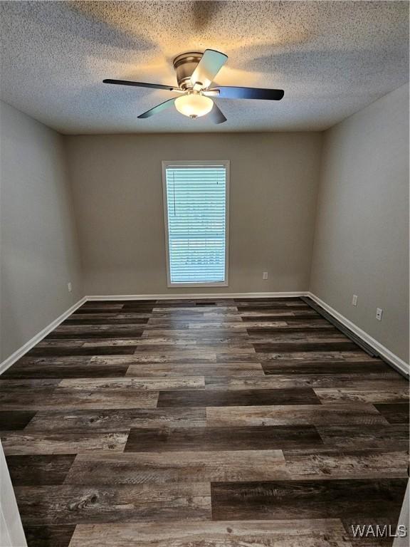 14541 Keenes Mill Rd, Coaling, AL 35453 - spare room featuring dark wood-type flooring, ceiling fan, a textured ceiling, and baseboards