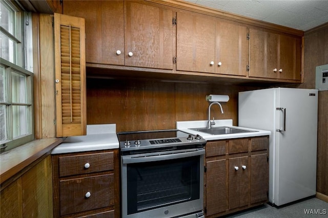 5204 Dove Creek Ave, Northport, AL 35473 - kitchen featuring electric range, freestanding refrigerator, a sink, and light countertops