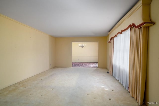 5204 Dove Creek Ave, Northport, AL 35473 - unfurnished room featuring a chandelier and light colored carpet