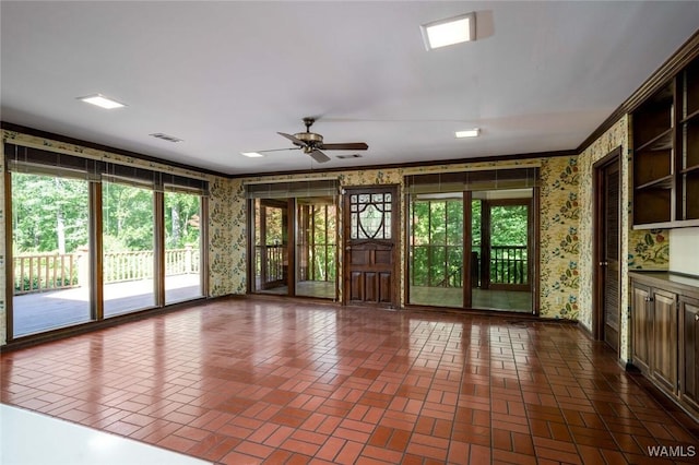 5204 Dove Creek Ave, Northport, AL 35473 - unfurnished living room featuring wallpapered walls, brick patterned floors, crown molding, baseboards, and a ceiling fan