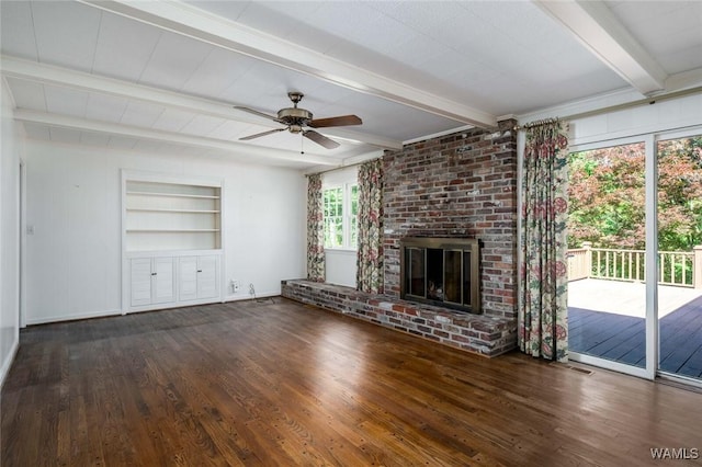 5204 Dove Creek Ave, Northport, AL 35473 - unfurnished living room featuring beamed ceiling, wood finished floors, built in shelves, ceiling fan, and a fireplace