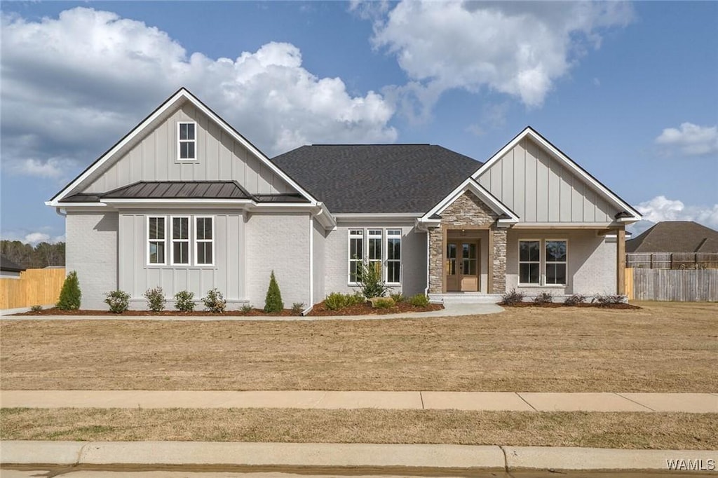 13911 Glenview Dr, Northport, AL 35475 - view of front of home featuring metal roof, board and batten siding, a standing seam roof, and fence
