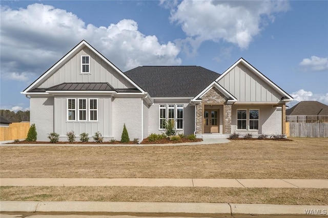 13911 Glenview Dr, Northport, AL 35475 - view of front of home featuring metal roof, board and batten siding, a standing seam roof, and fence