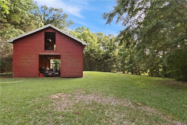 view of outbuilding featuring a yard