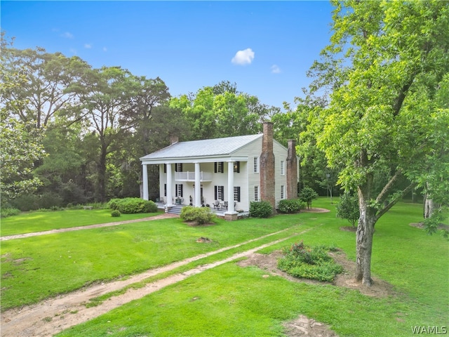 view of front of house with a porch and a front lawn