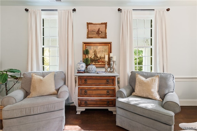 sitting room featuring plenty of natural light and dark hardwood / wood-style floors