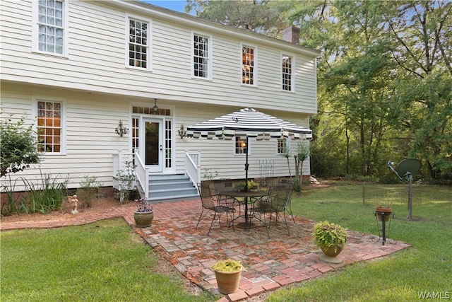 rear view of house with a yard and a patio