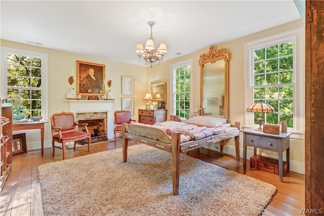 sitting room featuring hardwood / wood-style floors, plenty of natural light, and a notable chandelier