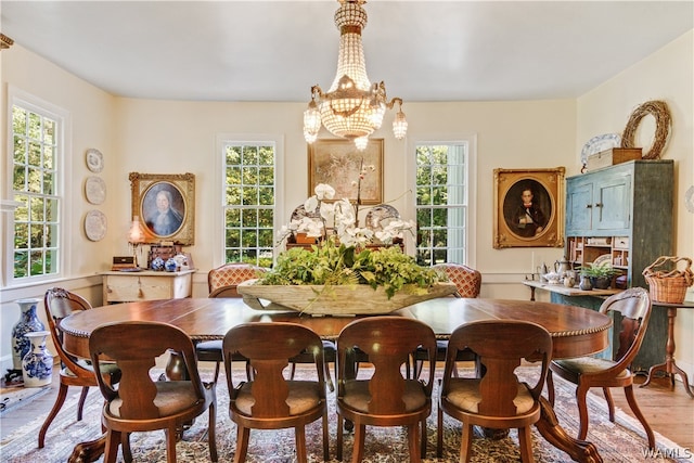 dining room with a chandelier and light hardwood / wood-style floors