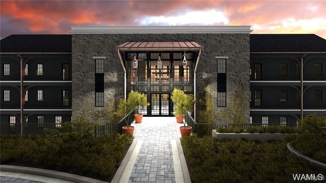 view of exterior entry featuring stone siding