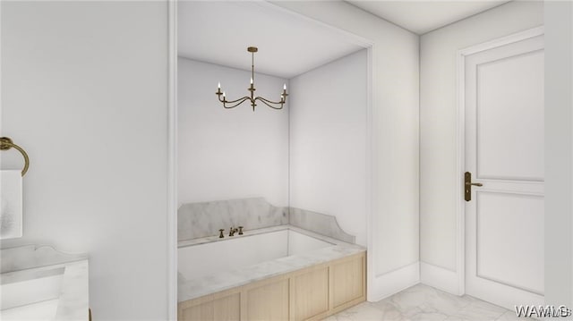 bathroom featuring a chandelier, a garden tub, and marble finish floor