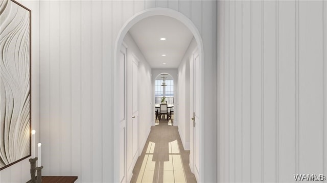 hallway with recessed lighting and arched walkways
