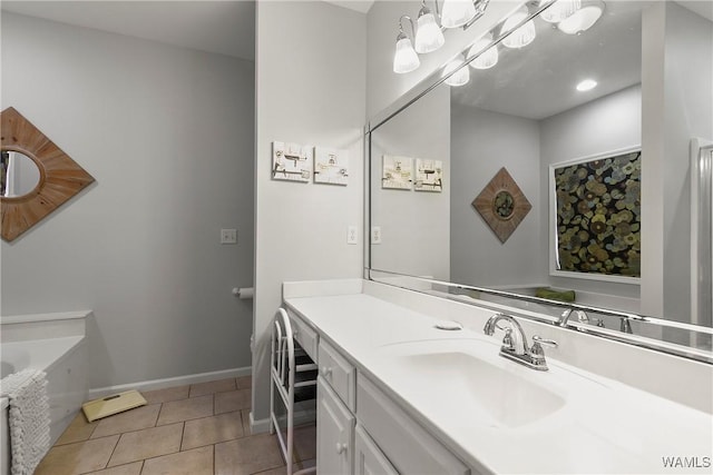 bathroom featuring a tub to relax in, vanity, and tile patterned floors