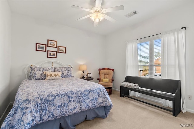 bedroom featuring ceiling fan and light carpet