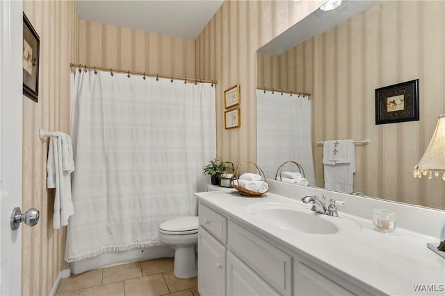 bathroom featuring toilet, tile patterned flooring, and vanity