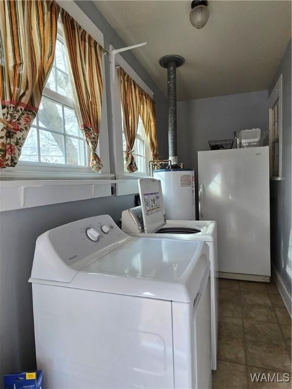 washroom with tile patterned flooring, separate washer and dryer, and water heater