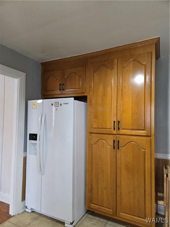 kitchen featuring white fridge with ice dispenser