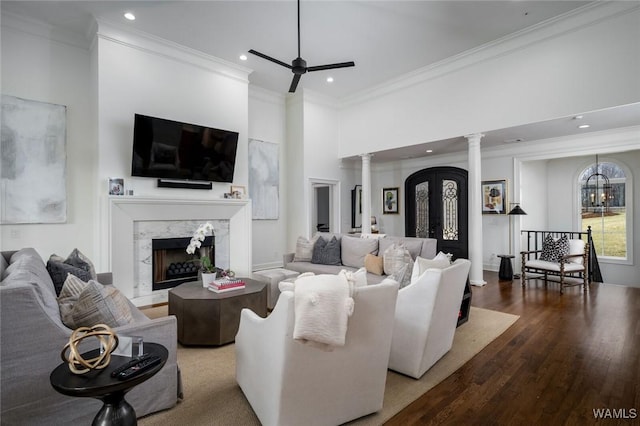 1901 Point Clear Rd, Tuscaloosa, AL 35406 - living area with a ceiling fan, a premium fireplace, wood finished floors, crown molding, and ornate columns