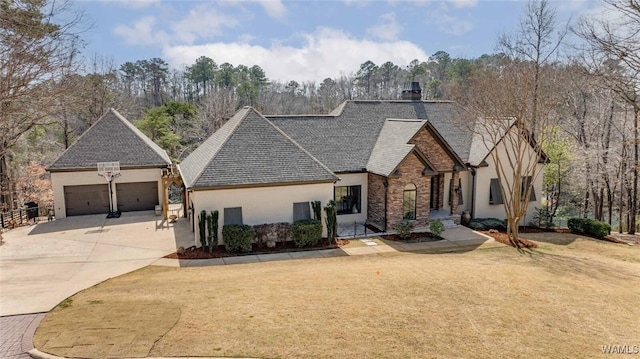 1901 Point Clear Rd, Tuscaloosa, AL 35406 - french country home featuring a garage, driveway, stone siding, stucco siding, and a front lawn