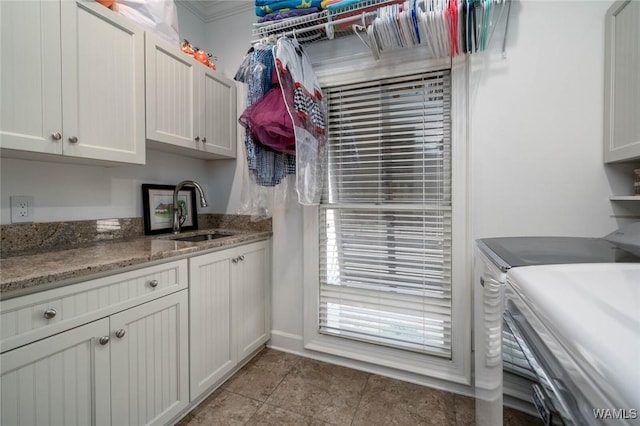 1901 Point Clear Rd, Tuscaloosa, AL 35406 - clothes washing area with light tile patterned floors, separate washer and dryer, a sink, and cabinet space