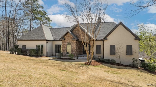 rear view of property featuring central AC, brick siding, a shingled roof, a lawn, and a chimney