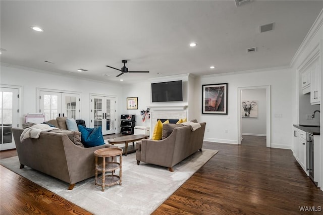 1901 Point Clear Rd, Tuscaloosa, AL 35406 - living area with dark wood finished floors, french doors, visible vents, and a fireplace