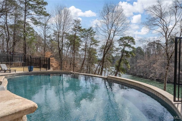 1901 Point Clear Rd, Tuscaloosa, AL 35406 - outdoor pool featuring a forest view and fence