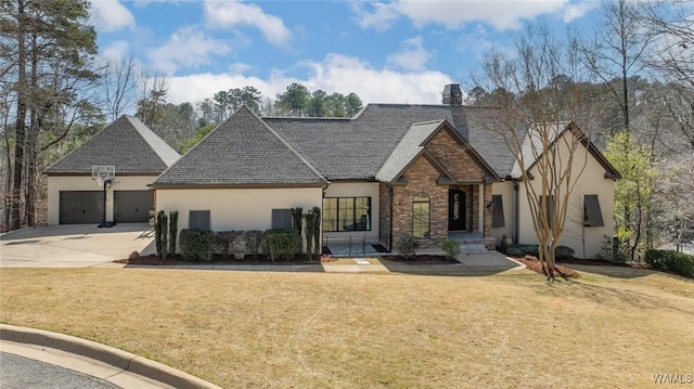 view of front of home featuring driveway, a chimney, an attached garage, a front yard, and brick siding