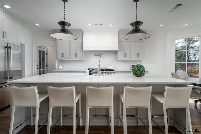 1901 Point Clear Rd, Tuscaloosa, AL 35406 - kitchen featuring custom exhaust hood, high end refrigerator, visible vents, and light countertops