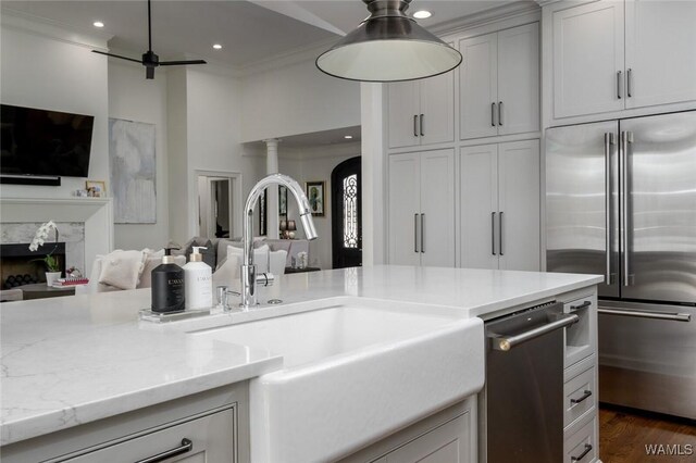 1901 Point Clear Rd, Tuscaloosa, AL 35406 - kitchen featuring a fireplace, a sink, open floor plan, appliances with stainless steel finishes, and ornamental molding