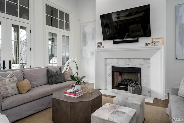 1901 Point Clear Rd, Tuscaloosa, AL 35406 - living room with a high end fireplace, french doors, baseboards, and wood finished floors