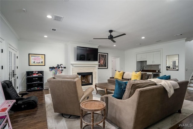 1901 Point Clear Rd, Tuscaloosa, AL 35406 - living room featuring a fireplace, visible vents, wood finished floors, and ornamental molding