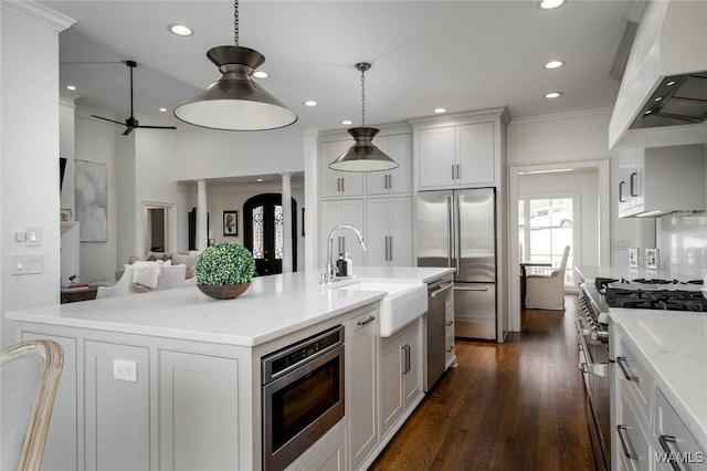 1901 Point Clear Rd, Tuscaloosa, AL 35406 - kitchen with premium appliances, premium range hood, dark wood-type flooring, white cabinetry, and open floor plan