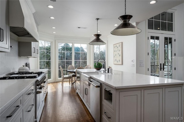 1901 Point Clear Rd, Tuscaloosa, AL 35406 - kitchen featuring stainless steel appliances, a healthy amount of sunlight, ornamental molding, and wall chimney exhaust hood