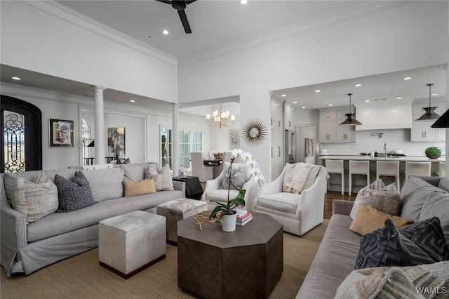 1901 Point Clear Rd, Tuscaloosa, AL 35406 - living area with recessed lighting, a high ceiling, crown molding, ornate columns, and ceiling fan with notable chandelier