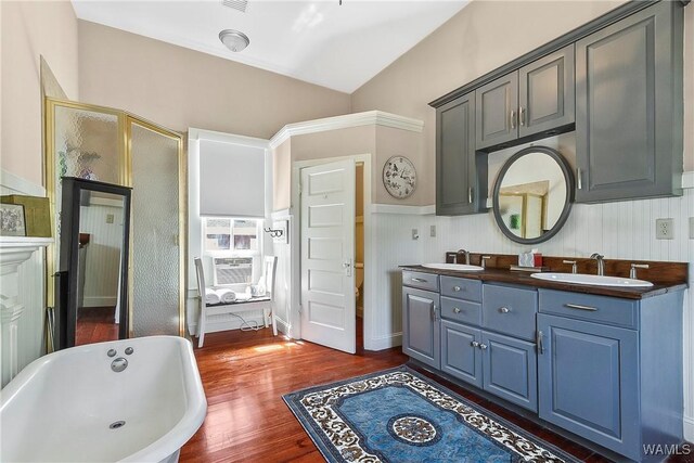 1601 Alaca Pl, Tuscaloosa, AL 35401 - bathroom featuring a wainscoted wall, hardwood / wood-style flooring, a stall shower, and a freestanding bath