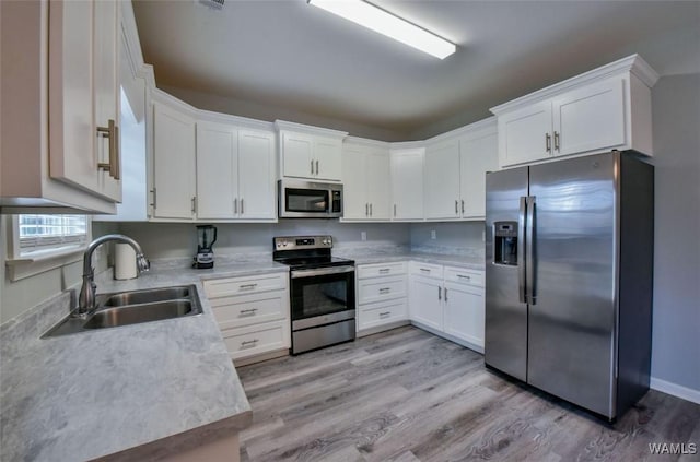 17818 Alecia Dr, Vance, AL 35490 - kitchen featuring stainless steel appliances, a sink, light countertops, and white cabinets