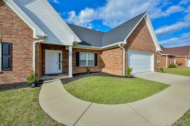 17818 Alecia Dr, Vance, AL 35490 - view of front of house with brick siding, an attached garage, a front yard, concrete driveway, and roof with shingles