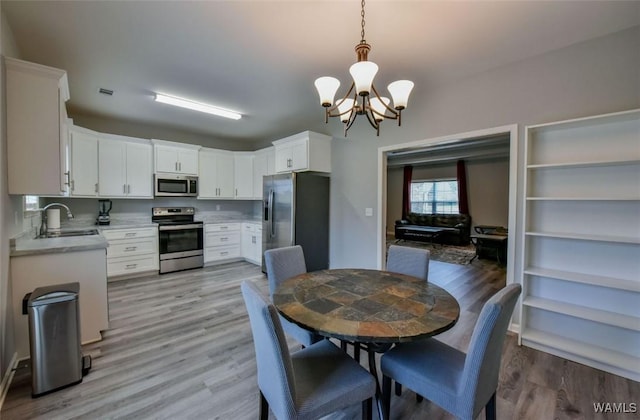 17818 Alecia Dr, Vance, AL 35490 - dining space with a chandelier and light wood finished floors