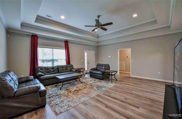 17818 Alecia Dr, Vance, AL 35490 - living room featuring a raised ceiling, ceiling fan, crown molding, wood finished floors, and baseboards