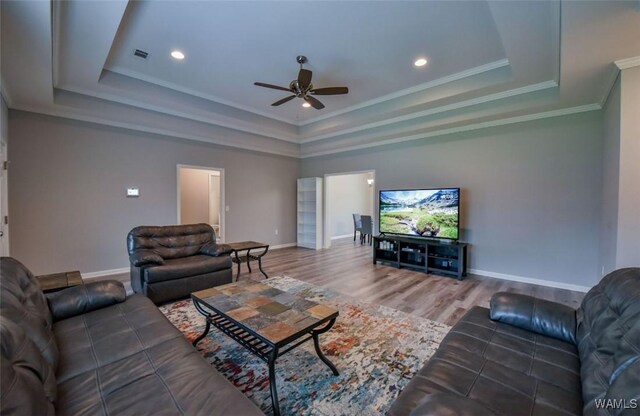 17818 Alecia Dr, Vance, AL 35490 - living area featuring a raised ceiling, a ceiling fan, wood finished floors, baseboards, and crown molding