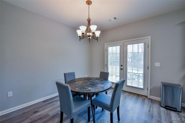 17818 Alecia Dr, Vance, AL 35490 - dining room with a chandelier, wood finished floors, french doors, and baseboards