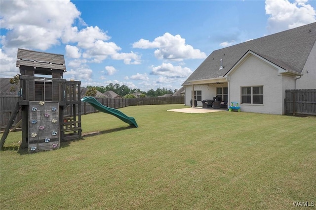 11210 Davis Pl, Northport, AL 35475 - fenced backyard featuring a playground and a patio area
