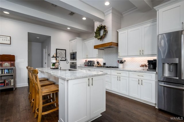 11210 Davis Pl, Northport, AL 35475 - kitchen featuring stainless steel appliances, dark wood finished floors, white cabinets, tasteful backsplash, and light stone counters