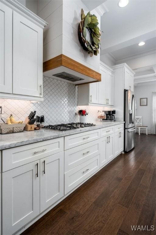 11210 Davis Pl, Northport, AL 35475 - kitchen featuring stainless steel appliances, white cabinetry, dark wood-type flooring, decorative backsplash, and beam ceiling