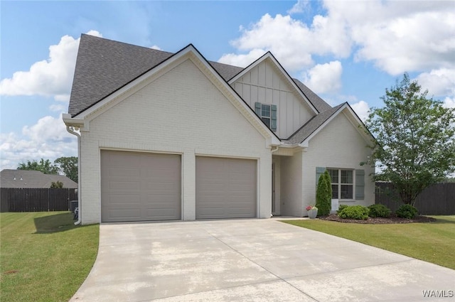 11210 Davis Pl, Northport, AL 35475 - view of front of house with board and batten siding, driveway, brick siding, and roof with shingles
